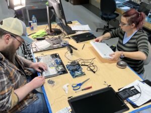 Steve's computer repair and data recovery San Antonio technicians professionally repairing and upgrading laptops inside of shop