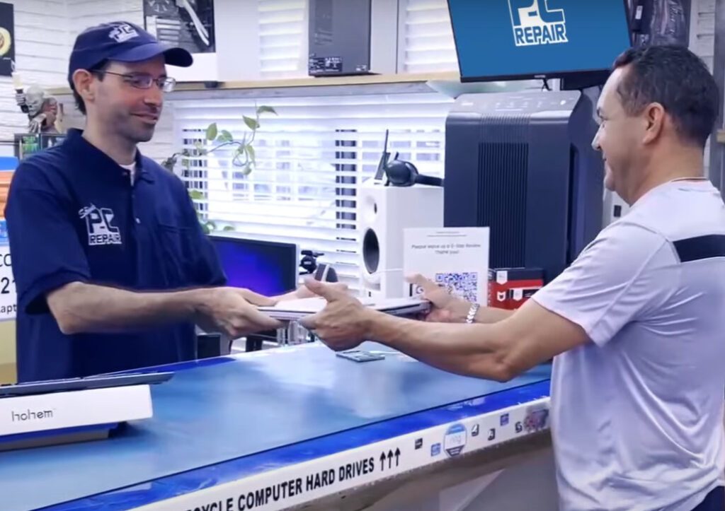 Steve handing Customer their finished laptop repair